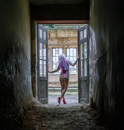 Zarte Detailaufnahme einer Frauenhand, die ein altes Fenster in einem Lost Place in Gera berührt. Sinnliche Fotografie mit Fokus auf Struktur und Licht.